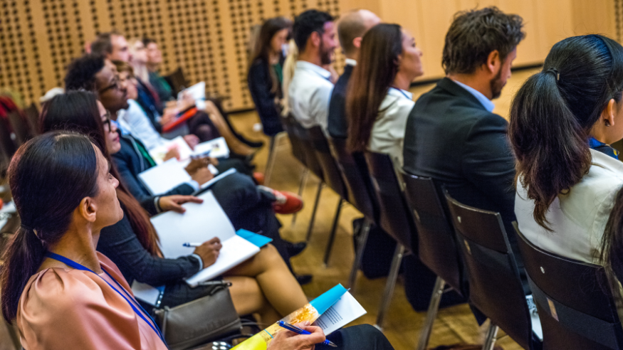 Business people in seminar at auditorium.